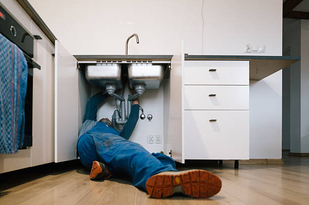 Professional Emergency Plumber technician working in Brookline Village, MA